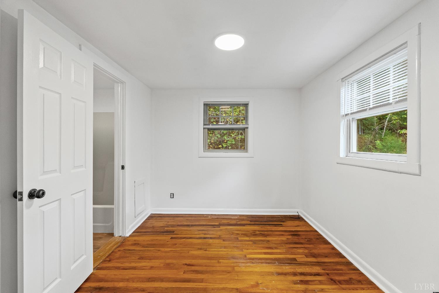 2758 Allens Creek Road Gladstone, VA 24553 - Photo 15 of 25 a view of an empty room with wooden floor and a window