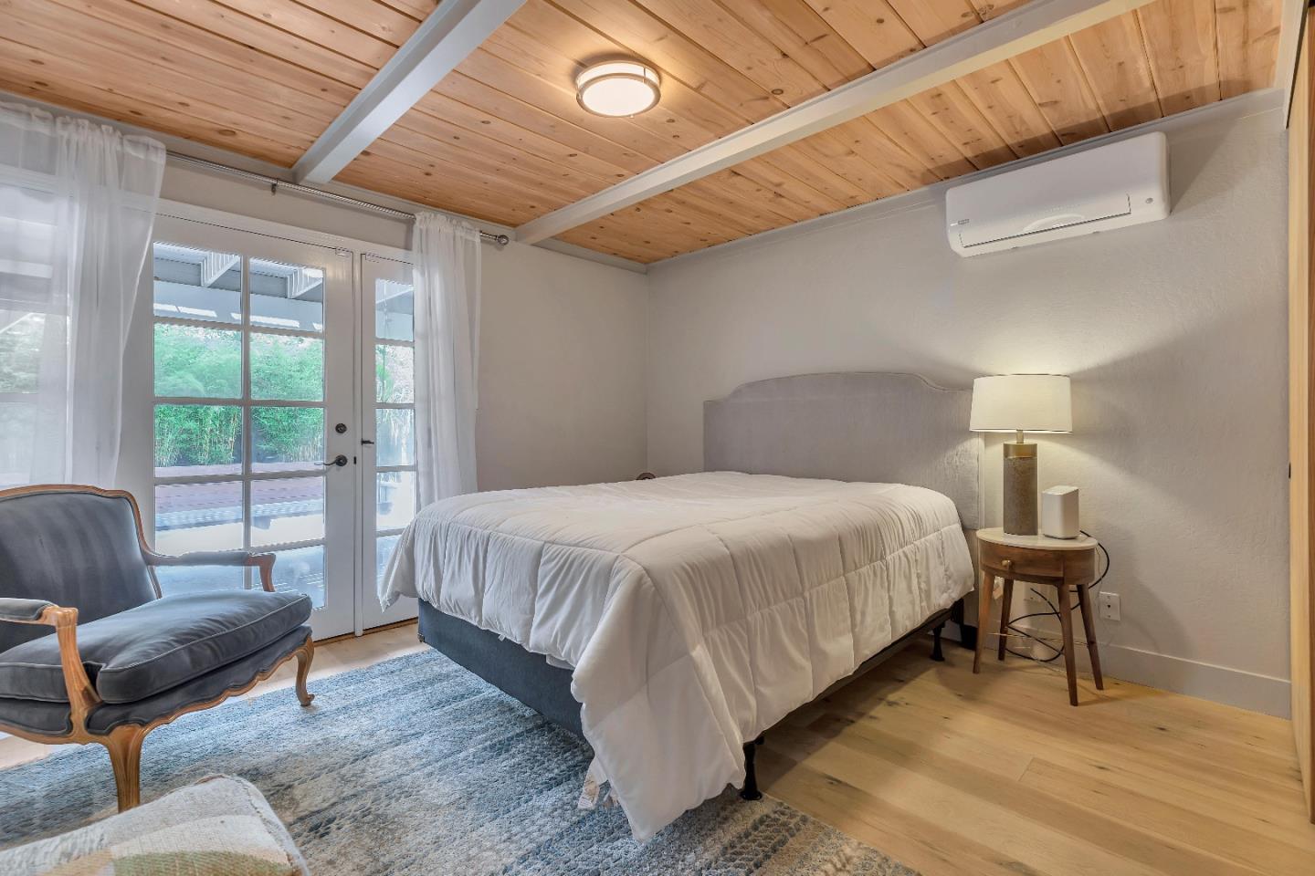 225 Treasure Island Drive Aptos, CA 95003 - Photo 25 of 63 a bedroom with a bed a couch and a large window with garden view