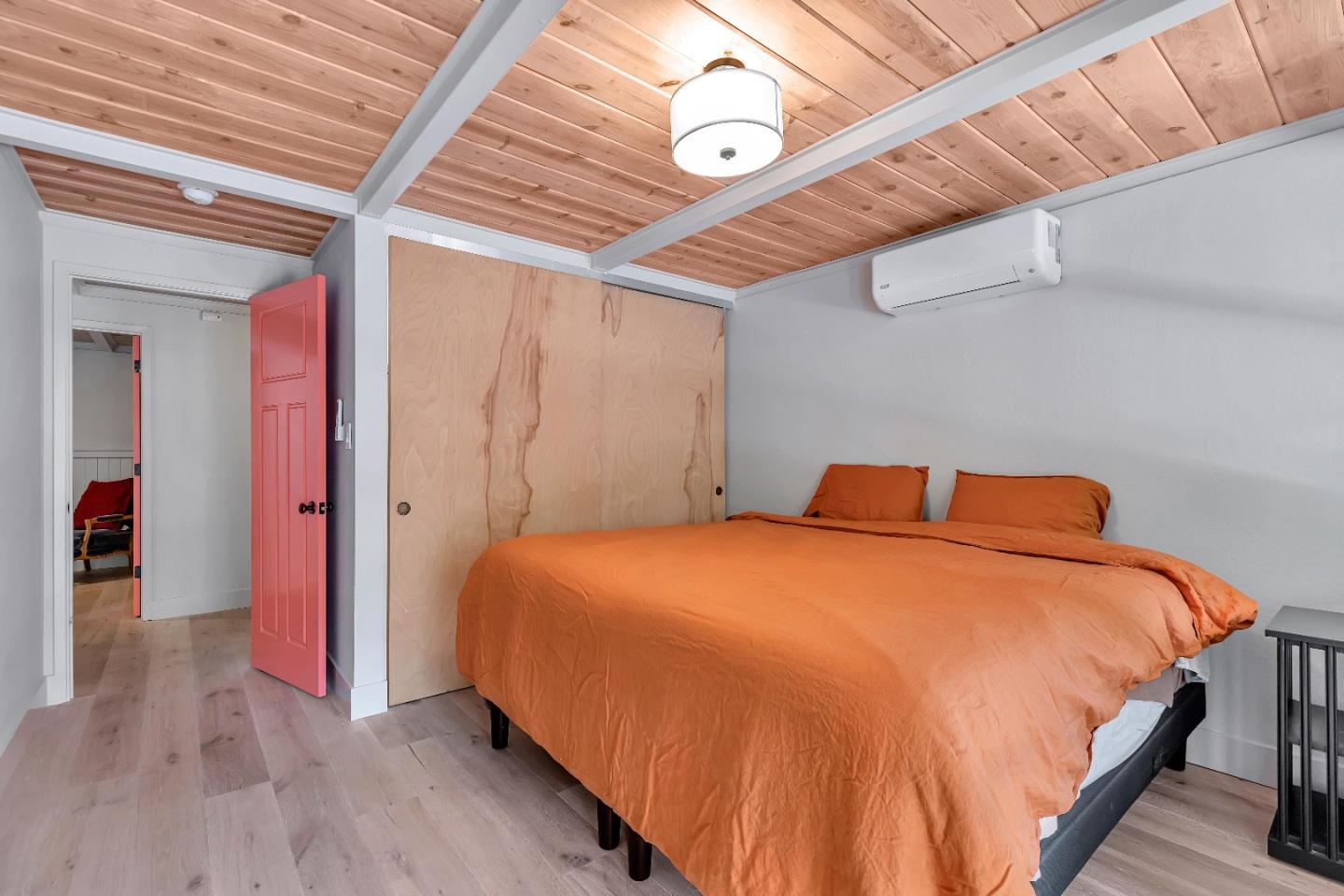 225 Treasure Island Drive Aptos, CA 95003 - Photo 26 of 63 a bedroom with a bed and a chandelier