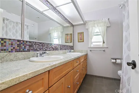 a bathroom with a granite countertop sink mirror and double