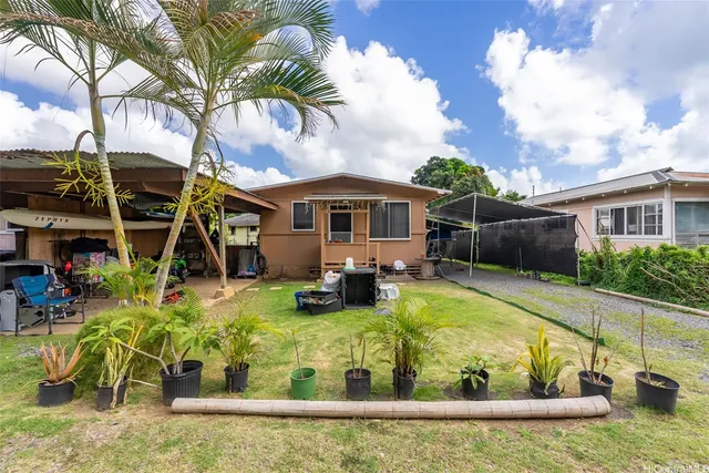 a view of a house with swimming pool and furniture