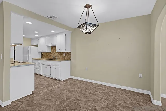 a kitchen with a refrigerator and a sink