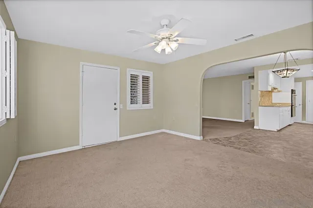 a view of an empty room with a chandelier