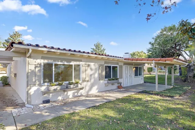 a view of a house with backyard porch and sitting area