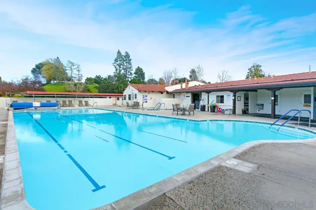 a view of a swimming pool with an outdoor seating