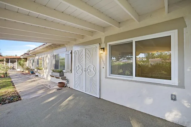 a view of a hallway with a large window and couch