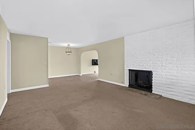 a view of an empty room with a fireplace