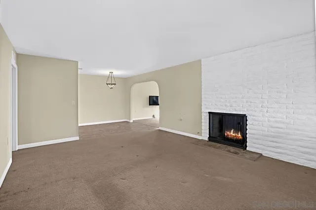 a view of an empty room with a fireplace