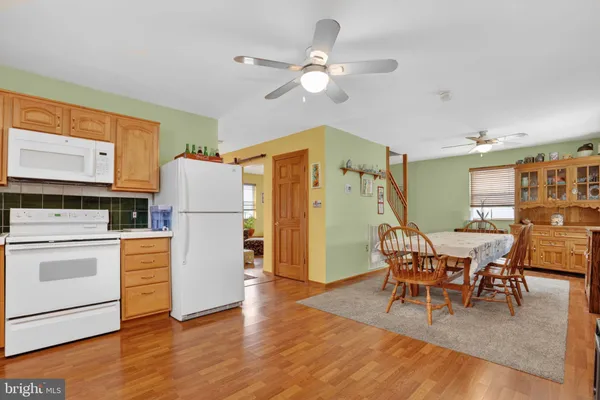 a kitchen with stainless steel appliances granite countertop a refrigerator and microwave