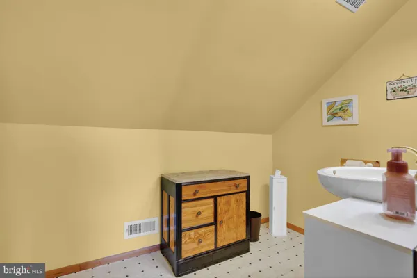 a bed sitting in a bedroom next to a window with wooden floor