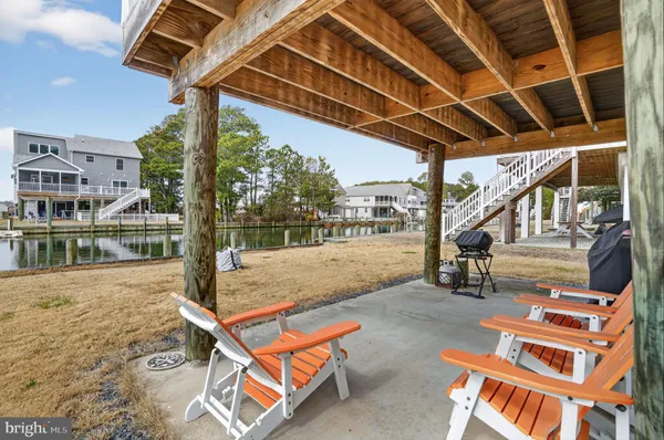 a view of a swimming pool with a patio and dining space
