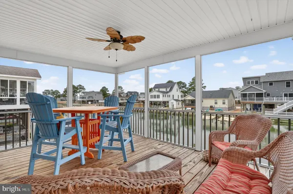 a dining room with furniture a rug and a floor to ceiling window