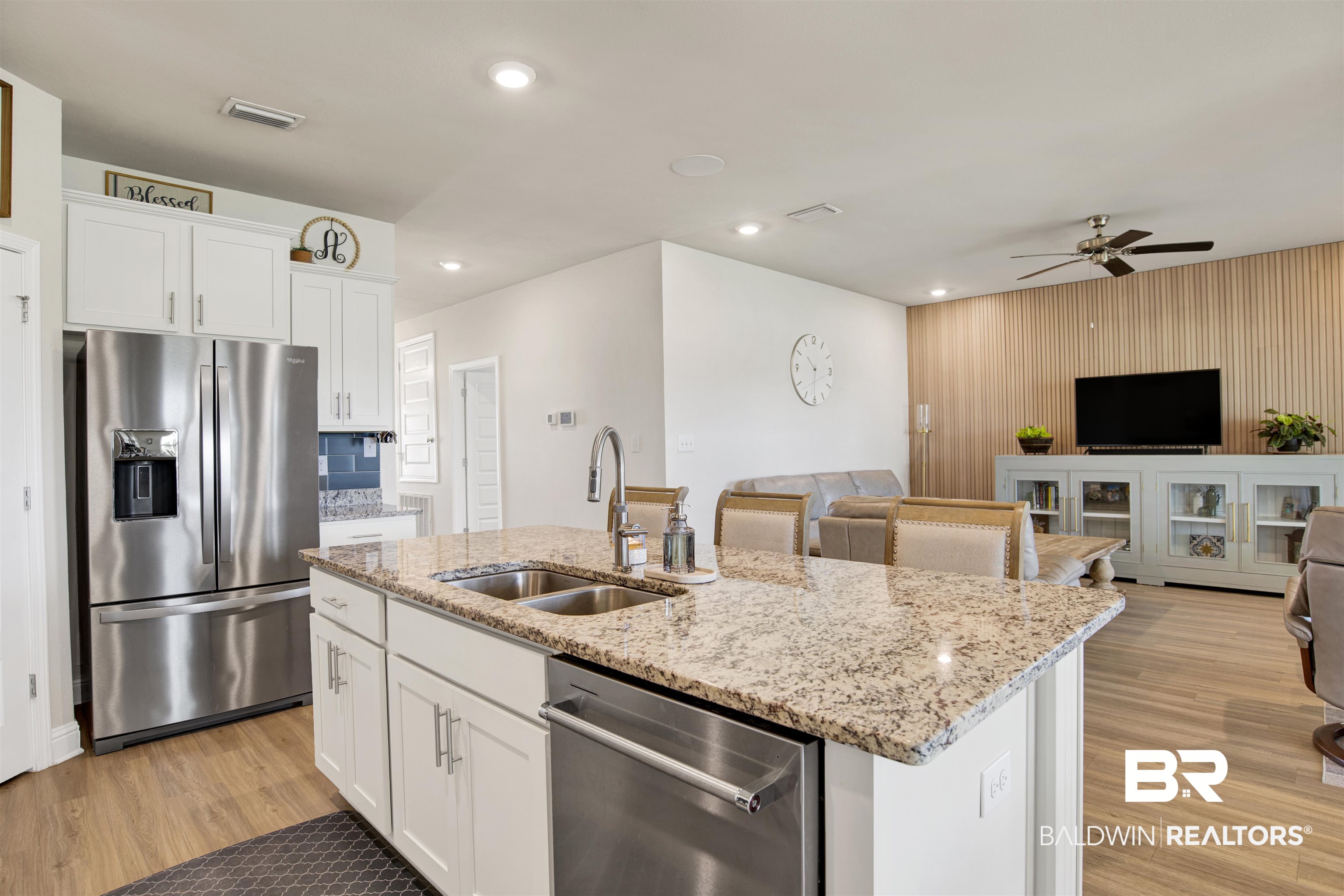 9431 Swan Point Road Daphne, AL 36526 - Photo 34 of 35 Kitchen featuring open floor plan, stainless steel appliances, a center island with sink, white cabinetry, and light wood-style flooring