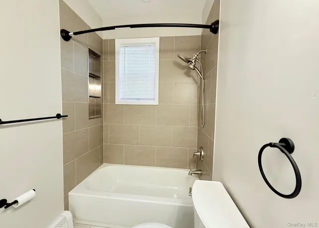 a bathroom with a granite countertop bathtub shower and a sink