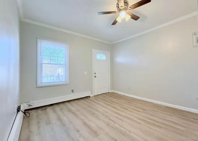 wooden floor in an empty room with a window