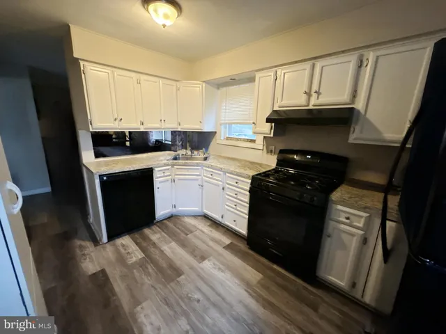 a kitchen with a sink and a stove