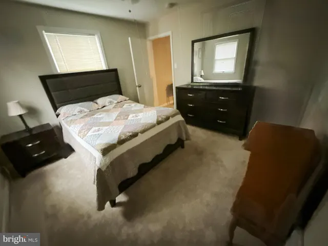 a bedroom with a bed and window