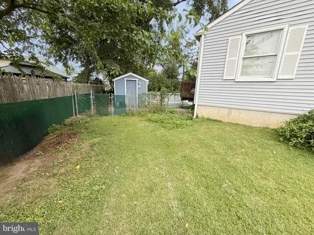 a yellow house with trees in front of it