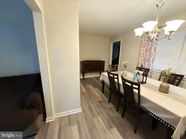 a living room with fireplace furniture and a rug