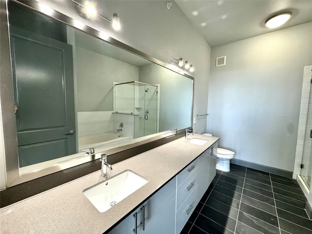 a bathroom with a double vanity sink and a mirror