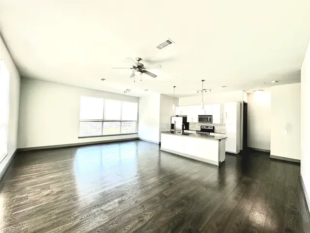 a view of a kitchen with a sink and a large window