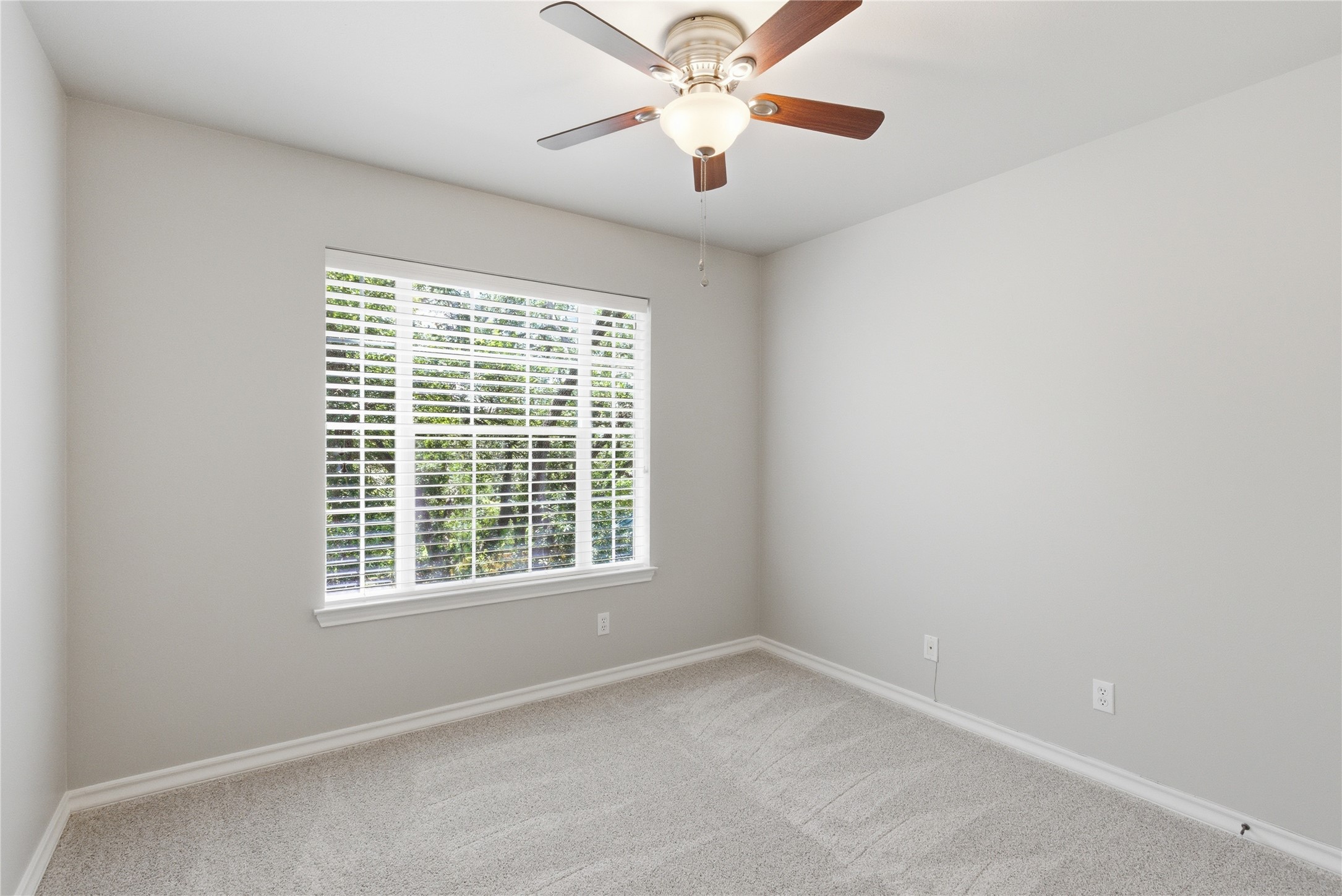 1204 Orlando Road Austin, TX 78733 - Photo 35 of 40 A window-filled bedroom with soft carpeting and a ceiling fan offers a peaceful personal retreat.