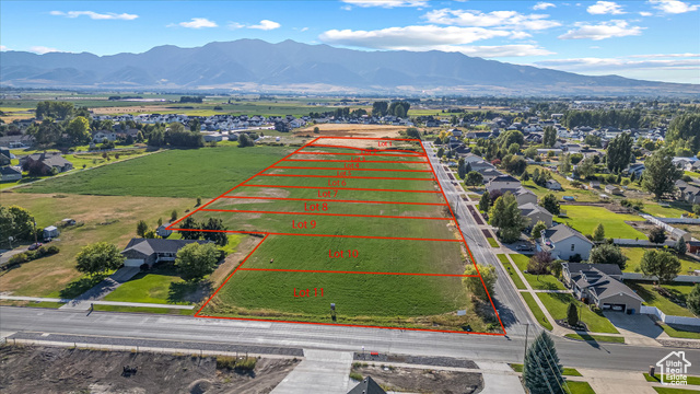 294 West 3400 South, Unit 9 Logan, UT 84321 - Photo 21 of 24 Aerial view of property and surrounding area featuring a mountain backdrop and property parcel outlined