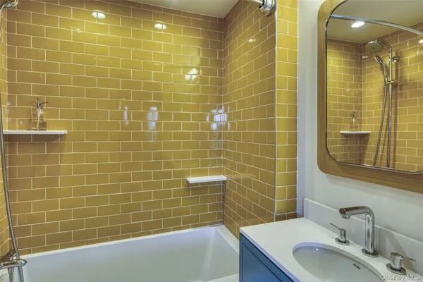 a bathroom with a sink a mirror and shower