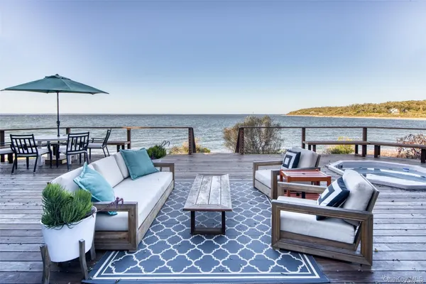 a outdoor living space with furniture and umbrella
