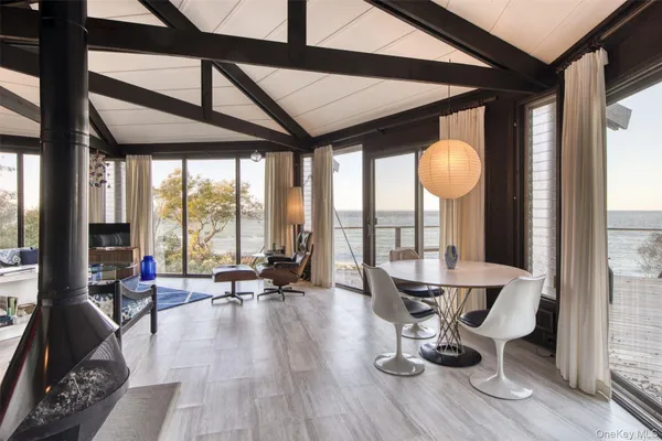 a living room with furniture and floor to ceiling windows
