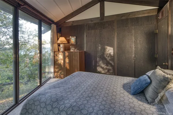 a bedroom with a large bed and a large window