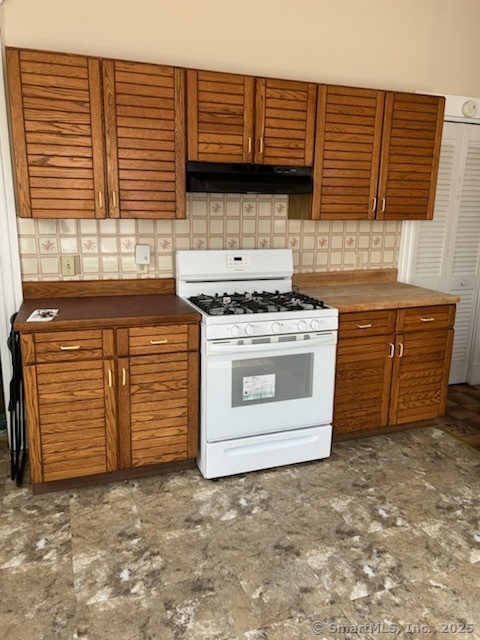 104 Howard Avenue New Haven, CT 06519 - Photo 4 of 9 a kitchen with granite countertop a stove top oven and cabinets