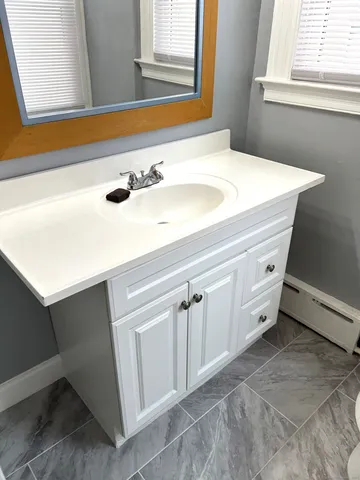 a bathroom with a sink and a mirror