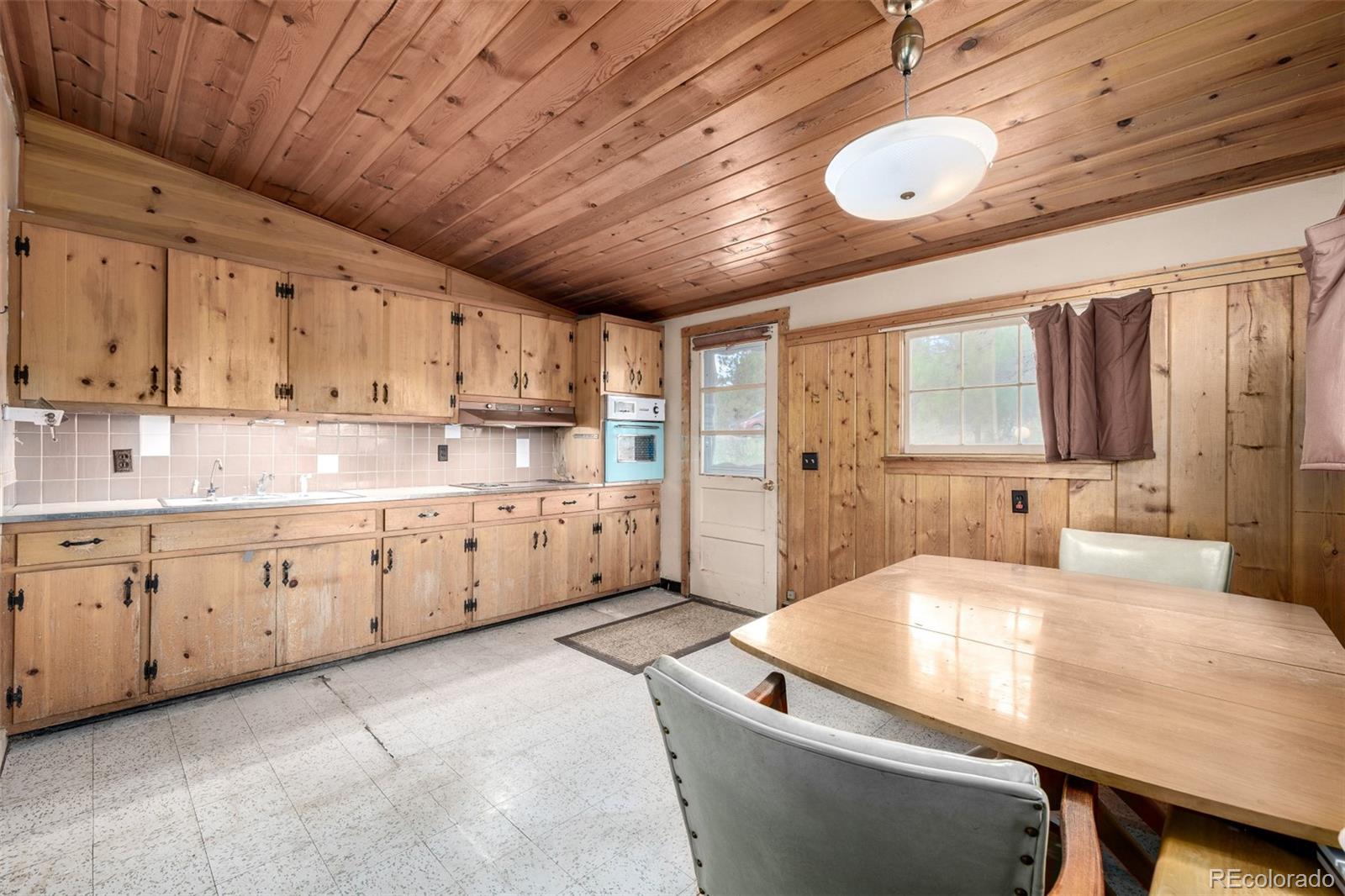 7105 Flagstaff Road Boulder, CO 80302 - Photo 11 of 45 a kitchen with kitchen island granite countertop lots of counter top space and wooden floors