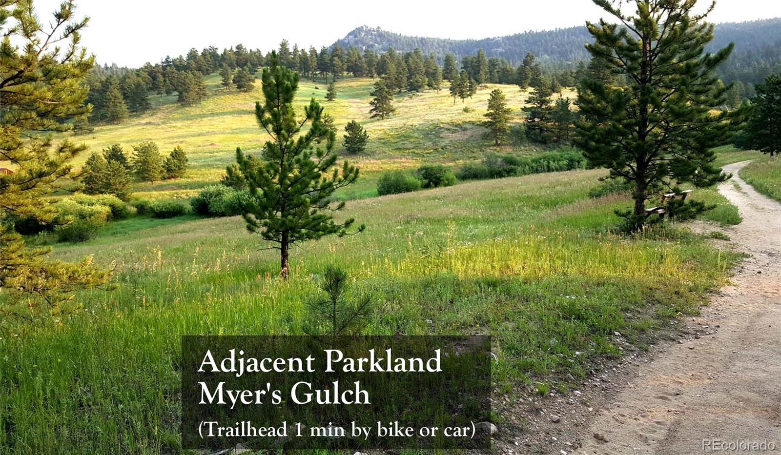 7105 Flagstaff Road Boulder, CO 80302 - Photo 41 of 45 a view of a lake with a big yard and large trees