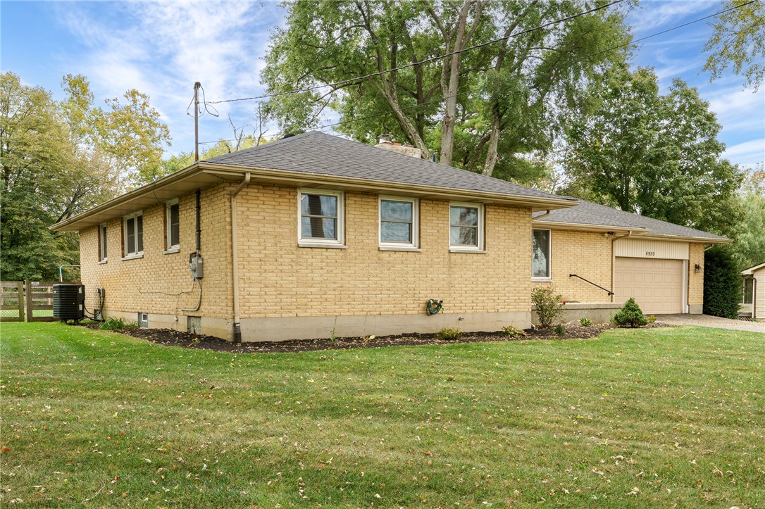 6950 Red Lion 5 Points Road Springboro, OH 45066 - Photo 5 of 78 This classic brick residence features a durable asphalt roof and a convenient attached garage.
