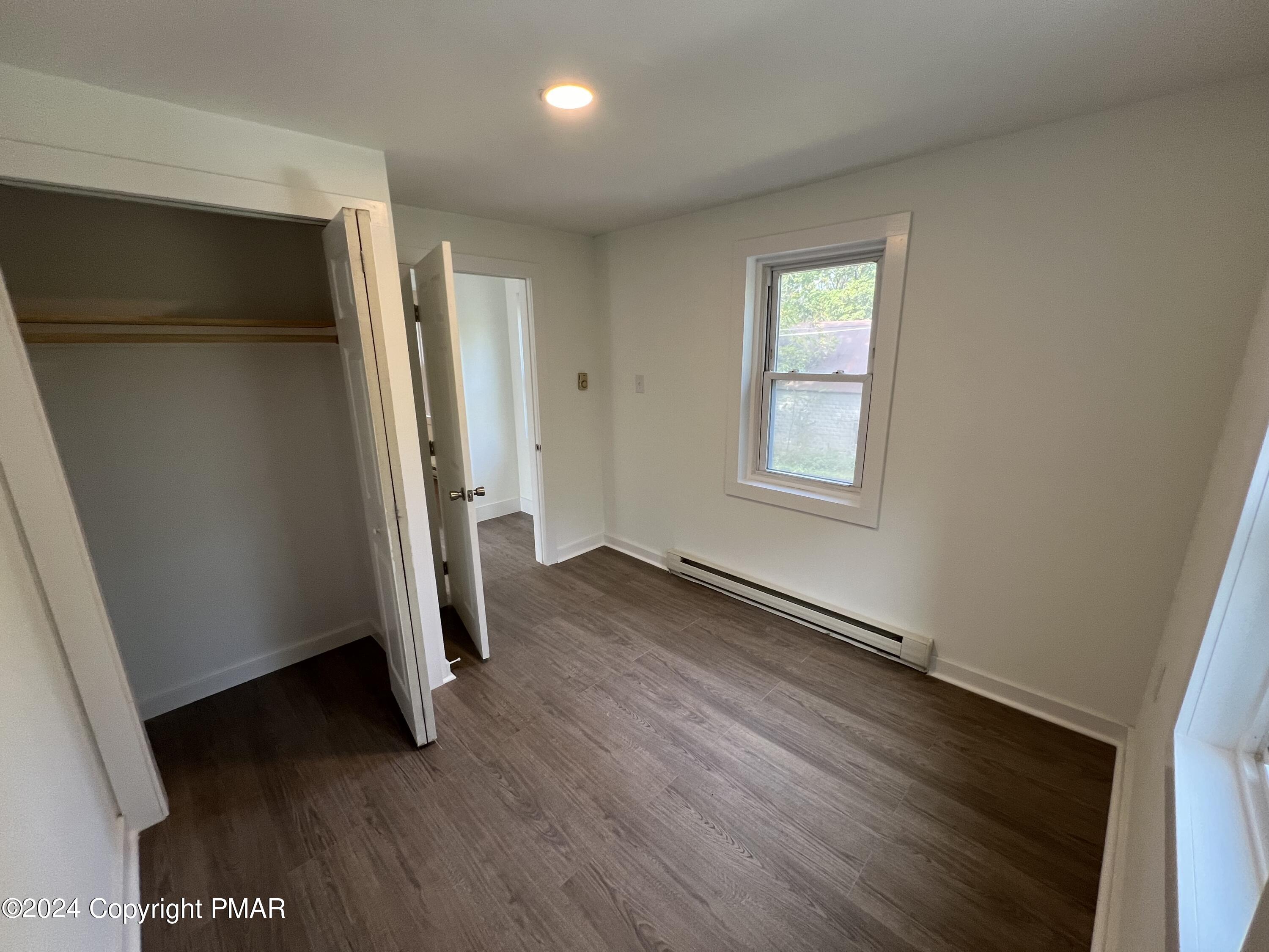 514 Fairground Road Gilbert, PA 18331 - Photo 13 of 20 an empty room with wooden floor and windows