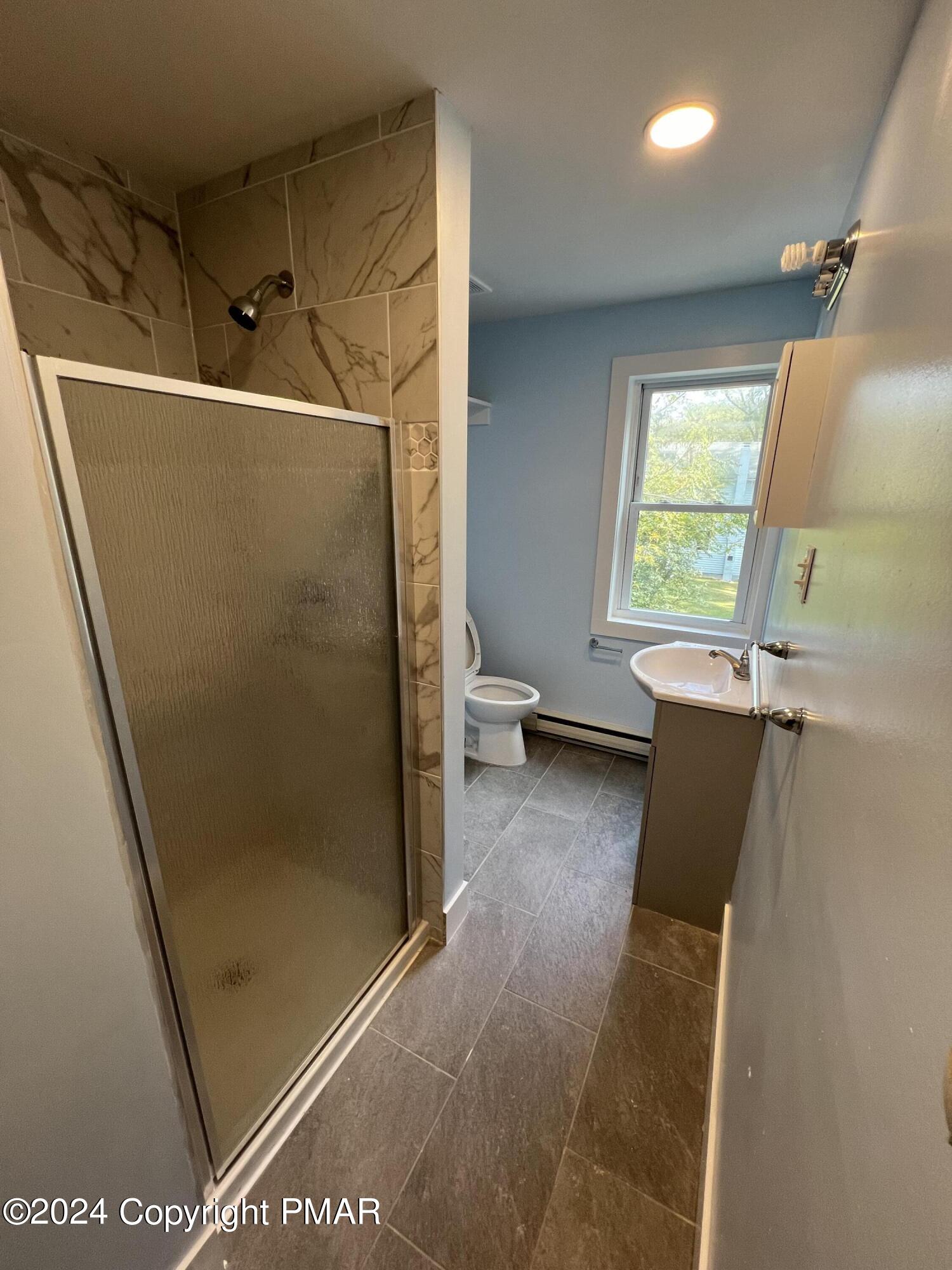 514 Fairground Road Gilbert, PA 18331 - Photo 14 of 20 a view of a bathroom with a tub and a shower