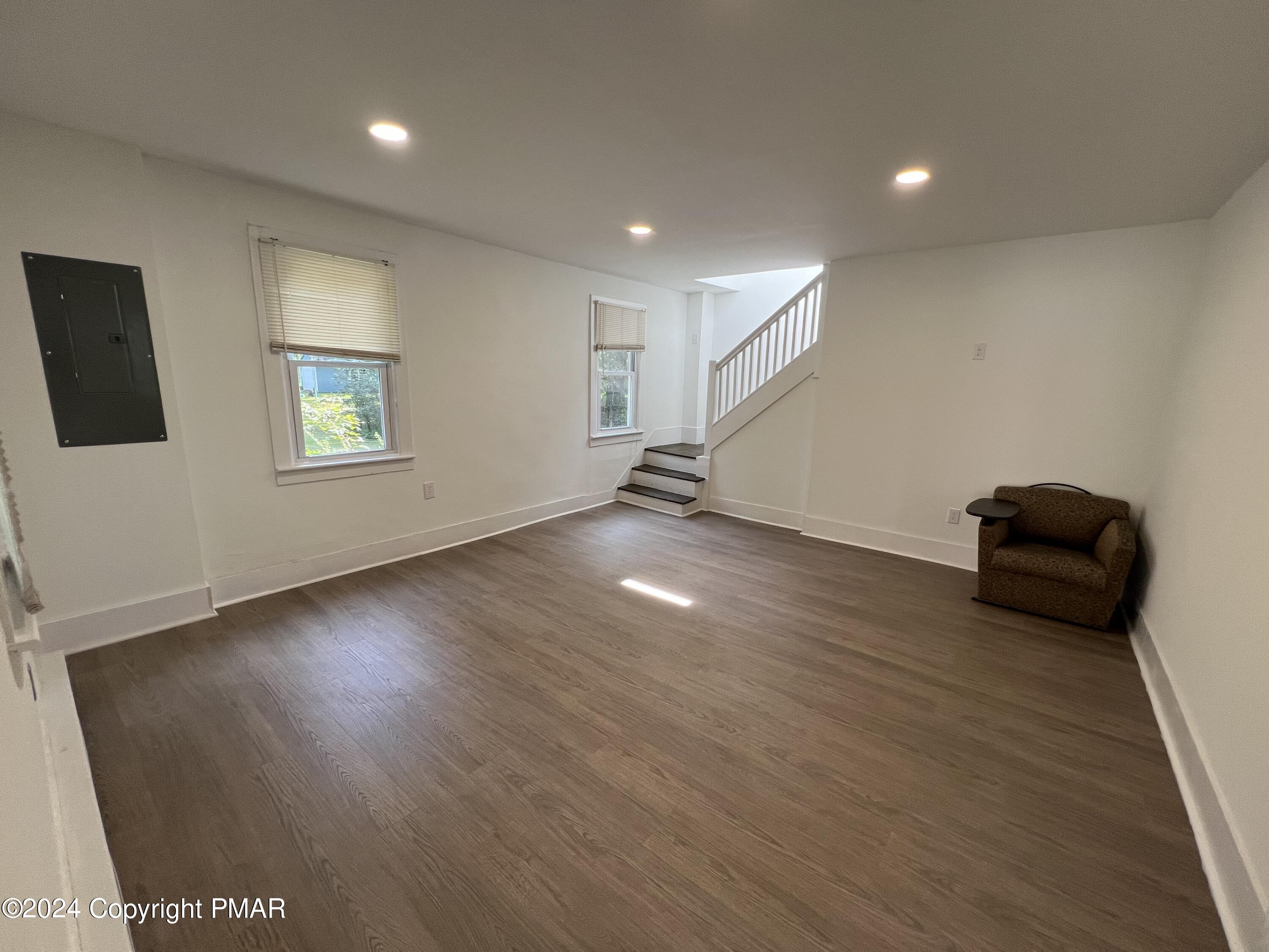 514 Fairground Road Gilbert, PA 18331 - Photo 4 of 20 a view of an empty room with wooden floor and a window