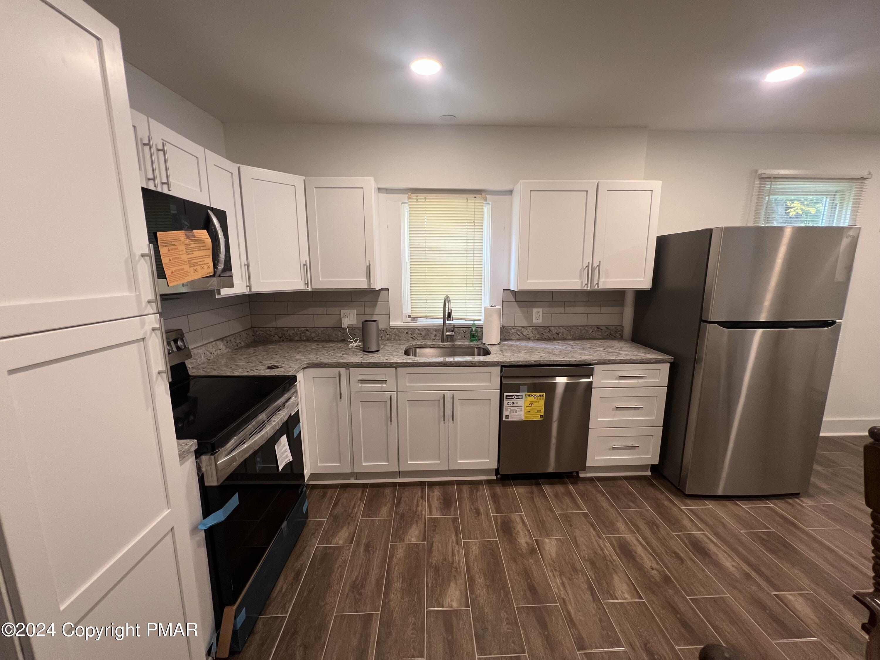 514 Fairground Road Gilbert, PA 18331 - Photo 7 of 20 a kitchen with a refrigerator sink and stove
