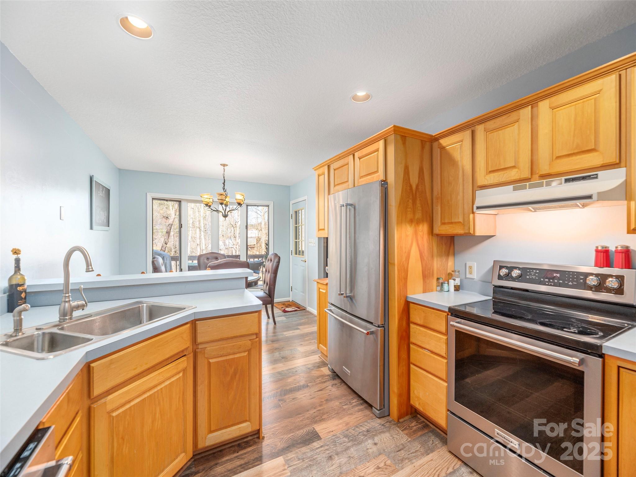 187 Turtle Creek Road Sylva, NC 28779 - Photo 11 of 36 a kitchen with stainless steel appliances granite countertop a stove a refrigerator and a sink