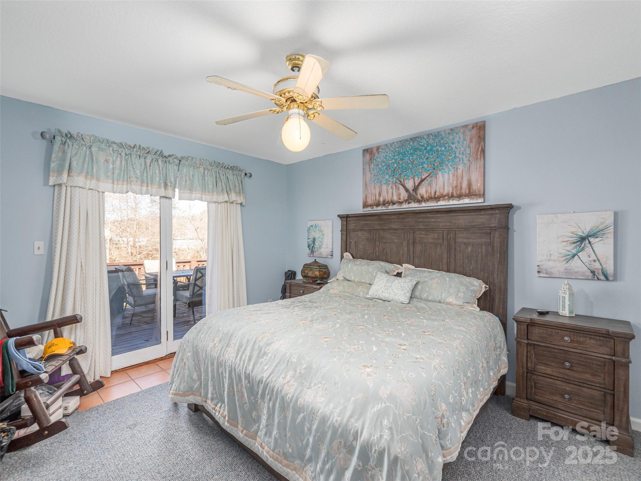 187 Turtle Creek Road Sylva, NC 28779 - Photo 14 of 36 a bedroom with a bed and a chandelier