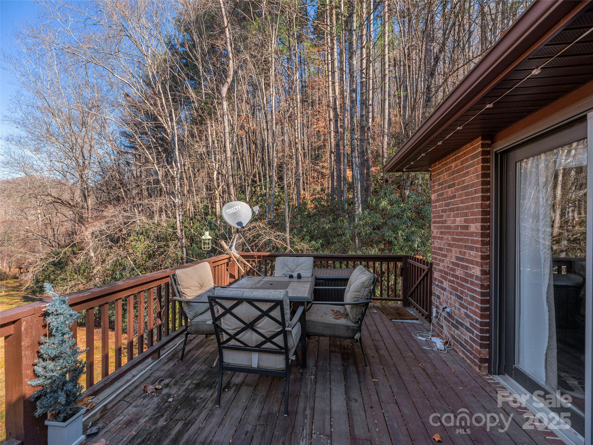 187 Turtle Creek Road Sylva, NC 28779 - Photo 24 of 36 a backyard of a house with table and chairs