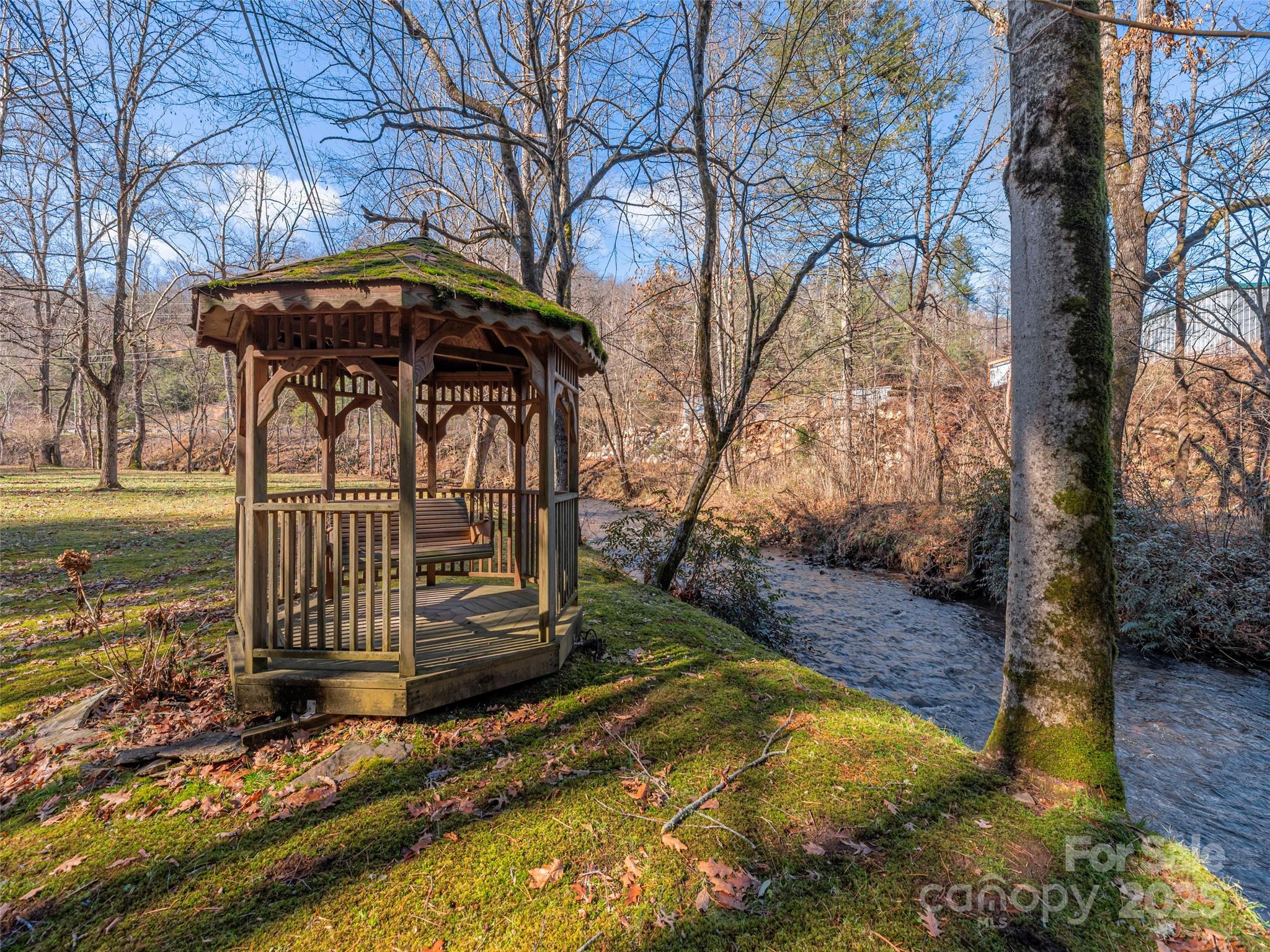 187 Turtle Creek Road Sylva, NC 28779 - Photo 29 of 36 a view of a wooden house with a yard covered with snow