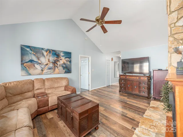 a view of a dining room with furniture a chandelier and wooden floor