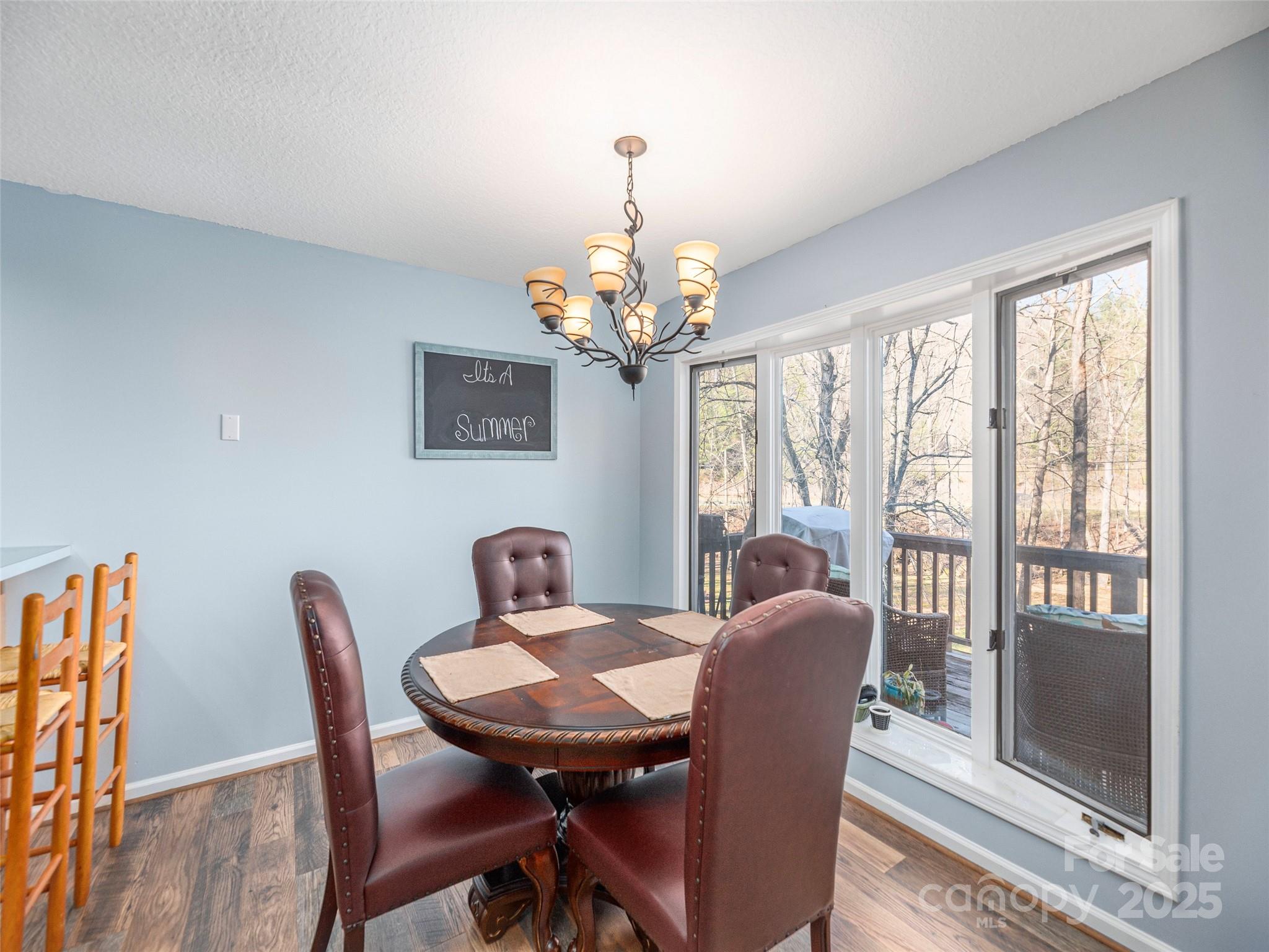 187 Turtle Creek Road Sylva, NC 28779 - Photo 7 of 36 a view of a dining room with furniture a chandelier and wooden floor