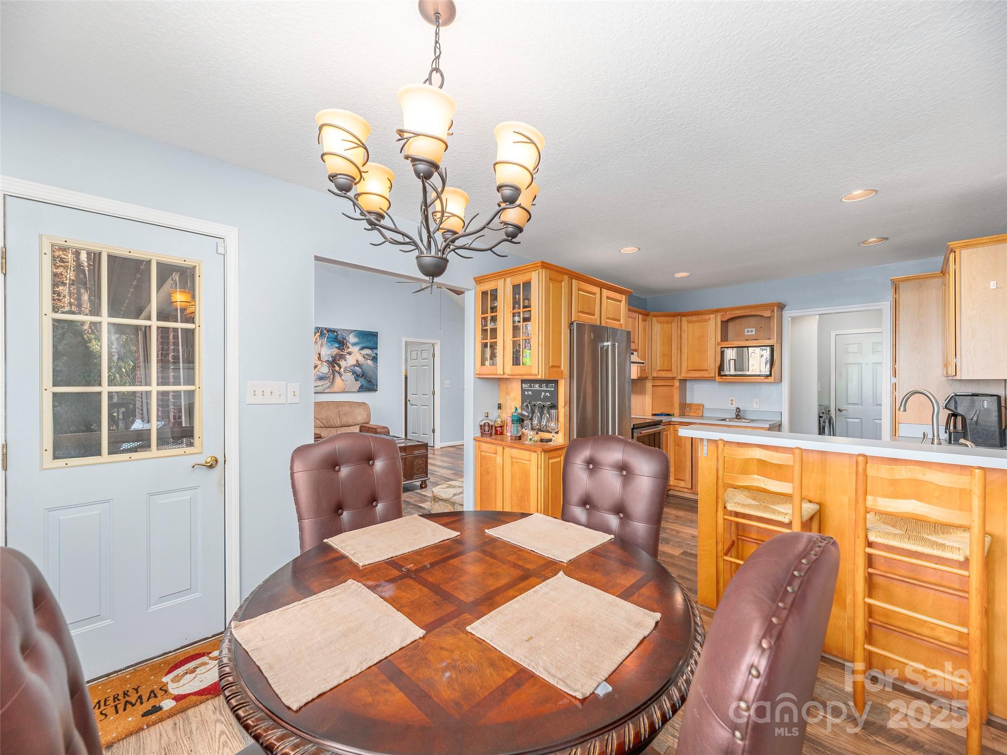 187 Turtle Creek Road Sylva, NC 28779 - Photo 8 of 36 a view of a dining room with furniture a chandelier and large windows