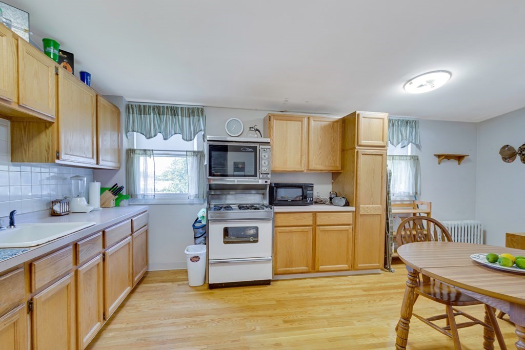 35 Madison Street Malden, MA 02148 - Photo 2 of 9 a kitchen with stainless steel appliances granite countertop a stove a sink dishwasher and a refrigerator with wooden floor
