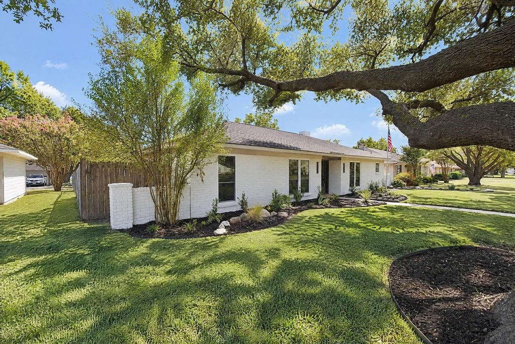 1904 Apollo Road Richardson, TX 75081 - Photo 39 of 40 Single-story residence featuring a white brick exterior, dark roof, and mature tree canopy