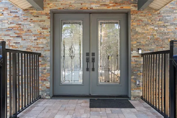a view of a room with wooden floor and chandelier
